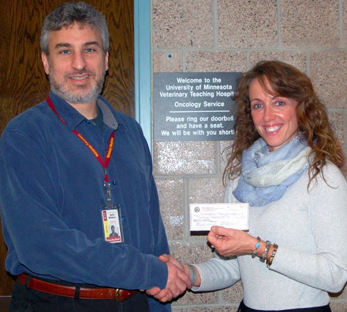 Dr. Teresa Lee Koogler, president of The Kate Koogler Canine Cancer Fund, Inc. presents Dr. Jaime Modiano researcher at University of Minnesota with a check for $25,000.00.